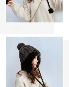 Detail of warm knit earflap hat featuring plush faux fur lining and large pom-pom detail