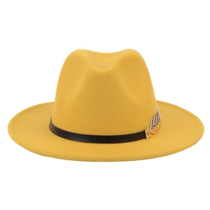 Detail of yellow wool fedora hat with black leather band and golden feather buckle