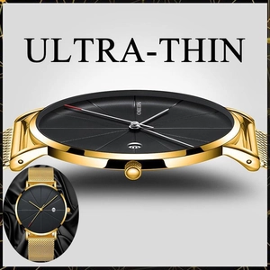 Detail view of ultra-thin quartz watch with gold mesh band and black minimalist dial