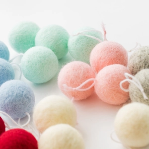 Handmade wool felt balls with hanging ropes in pastel colors for DIY Christmas tree decor
