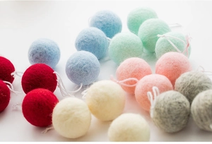 Detailed view of colorful wool felt balls in macaron tones for Christmas DIY decorations