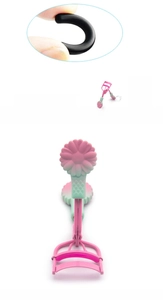 Detail view of two-tone eyelash curler with daisy floral handles and silicone pads