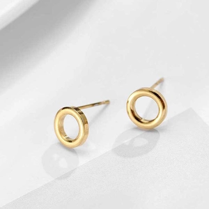 Macro detail of high-polish gold hoop earrings with a sleek minimalist geometric design