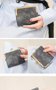 Detail of vintage gray faux leather wallet featuring a gold-tone kiss lock and side zipper