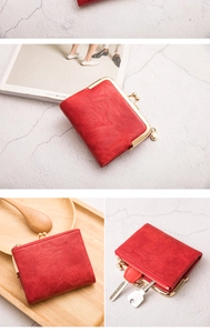Detail of red vintage kiss-lock wallet with metal clasp and side zipper for coins and keys