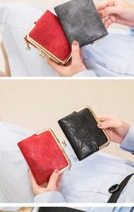 Detail of vintage women's mini wallet showing retro kiss-lock closure and leather texture