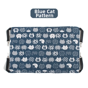 Detail of blue rectangular cat hammock with white feline patterns and adjustable straps