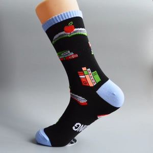 Black Christmas cotton socks with book and apple patterns on light-colored mannequin legs