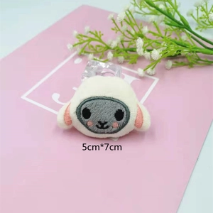 Close-up of cute plush sheep accessory with grey face and 5x7cm size detail