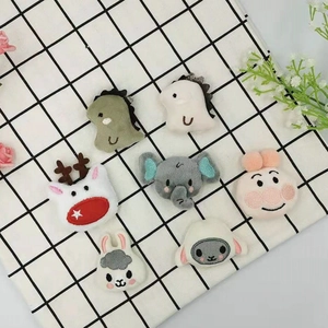 Detailed view of assorted plush cartoon animal accessories for DIY crafts and decor