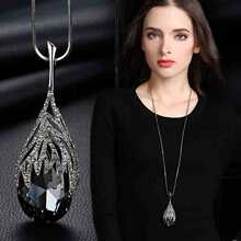 Detail of dark crystal teardrop pendant with micro-inlaid gold plating and model view