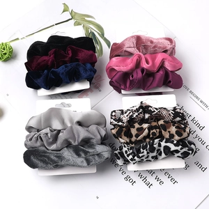 Three-piece fabric scrunchies set with velvet and satin textures in leopard and solid colors
