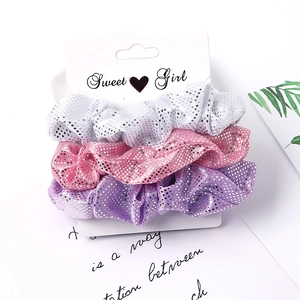 Three-piece fabric scrunchie set in white, pink and purple with sparkling silver accents