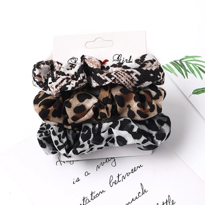 Three-piece leopard print scrunchie set in chiffon fabric on a branded card