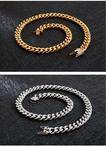 Detail of gold and silver cuban chain necklaces with crystal studded clasps on black texture