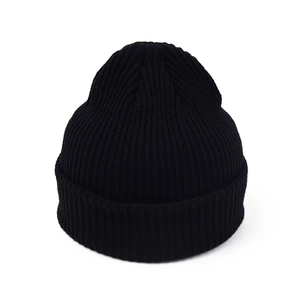 Detailed view of thick ribbed knit texture and wide cuff on black winter beanie