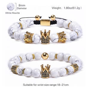 8mm White Howlite bead bracelet set with gold crown and black zircon charms on white background
