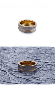 Detail of two-tone stainless steel ring featuring LOVE ONLY YOU engraving and brushed finish