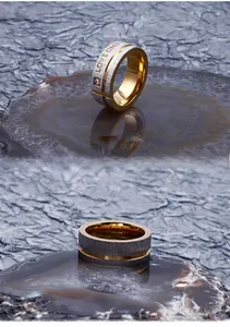 Detail view of two-tone stainless steel ring with LOVE ONLY engraving and a small zircon