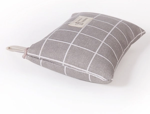 Detail of grey checkered cotton linen storage bag with handmade fabric label on top