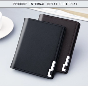 Detail view of stylish men's slim wallets in black and brown leather with metallic accents