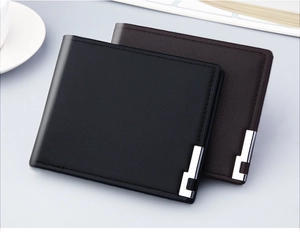 Close-up of black and dark brown men's bi-fold wallets with metallic corner accents