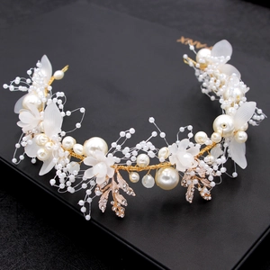 Detail of handmade gold leaf headband with delicate white pearls and sparkling rhinestones