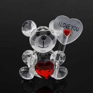 Macro shot of faceted crystal teddy bear holding a red heart with I Love You text