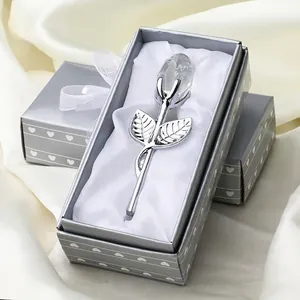 Detail view of a crystal rose gift with silver stem inside an elegant white satin-lined box