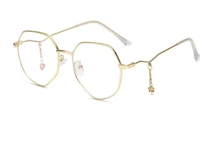 Detail of polygonal gold eyeglass frame featuring unique star and heart charm chain temple
