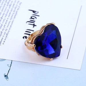 Close-up of deep blue heart-shaped crystal ring with adjustable golden band