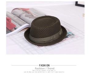 Close-up of olive green mesh fedora hat featuring woven texture and ribbon detail