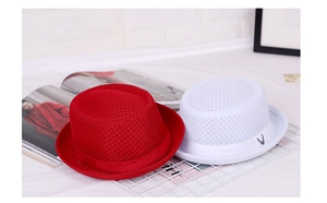 Detail showing red and white breathable mesh jazz hats with ribbon on a rack