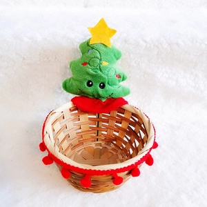 Detail of bamboo Christmas basket with green plush tree and yellow star decoration