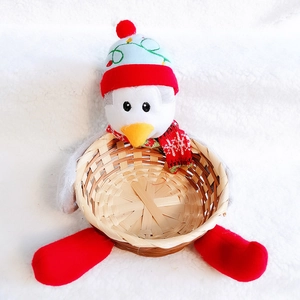Close-up of a Christmas penguin storage basket made of woven bamboo and soft plush