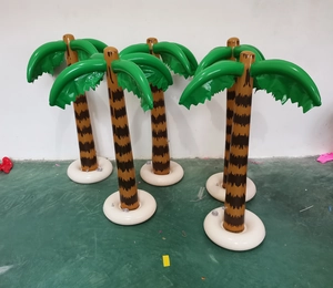 Row of four inflatable PVC coconut palm trees with green leaves and brown trunks