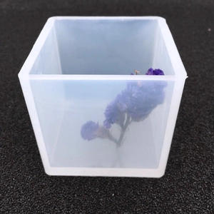 Macro shot of square translucent silicone mold with purple dried flower for resin DIY