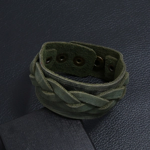 Close-up of vintage green braided leather bracelet with adjustable metal snap button