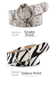 Detail of round buckle belts in snake skin print and black and white zebra pattern