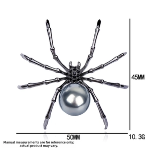 Macro detail of a vintage black spider brooch with rhinestones and grey pearl inlay