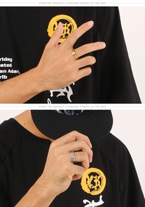 Close-up of gold and silver stainless steel screw motif rings worn on fingers