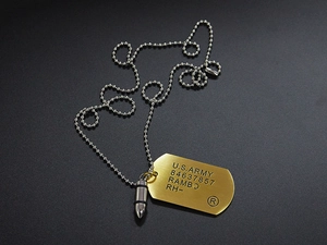 Detailed close-up of Rambo U.S. Army dog tag necklace with a gold bullet pendant