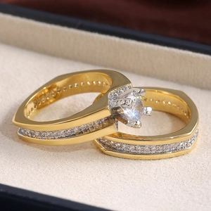 Macro shot of luxury two-piece gold plated ring set with brilliant round diamond stones