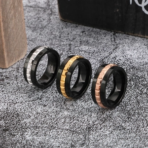 Three men's titanium steel rings with gear texture in black, gold, and rose gold