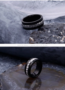 Detailed view of black stainless steel men's ring with silver gear inlay on rock