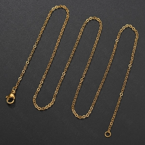 Detail of 18k gold plated stainless steel O-chain with lobster clasp on black background
