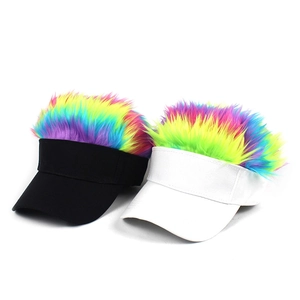 Detail of white and black sun visors with vibrant rainbow faux hair on plain white background