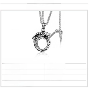 Detailed macro view of titanium steel Ouroboros dragon pendant with wheat style metal chain