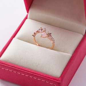 Macro shot of rose gold floral ring with pink zircon set in a pink velvet jewelry box