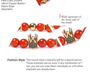 Detail of 8mm red agate bracelet with gold crown pendants and black zircon inlay